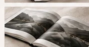 Open layflat photo book showing panoramic landscape spreads