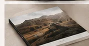 Softcover landscape photo book on a neutral surface