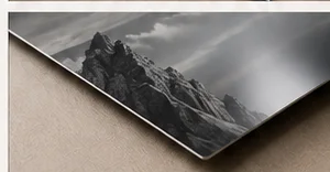 Black-and-white mountain photograph printed on a metal panel