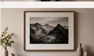 Framed mountain photograph displayed on a warm neutral wall